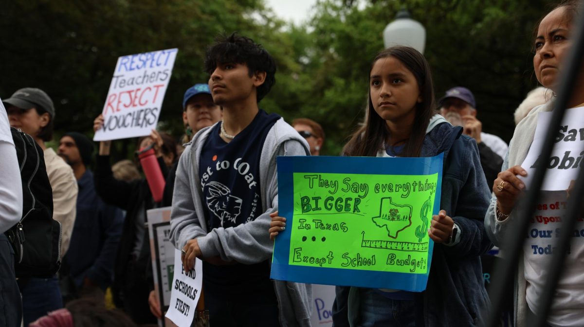 Protesters hold up signs opposing policies that fund private education during the Save Texas Schools Rally at the Texas Capitol Saturday. Justin Doud/TSTV News