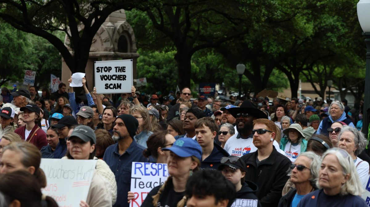 Protesters hold up signs opposing policies that fund private education during the Save Texas Schools Rally at the Texas Capitol Saturday. Justin Doud/TSTV News