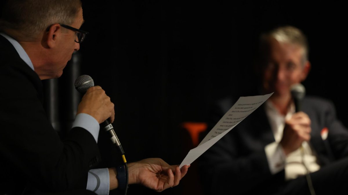 Evan Smith holds a paper with notes during a conversation with SMU President Jay Hartzell, who previously led UT Austin, at the Texas Tribune Festival Thursday.