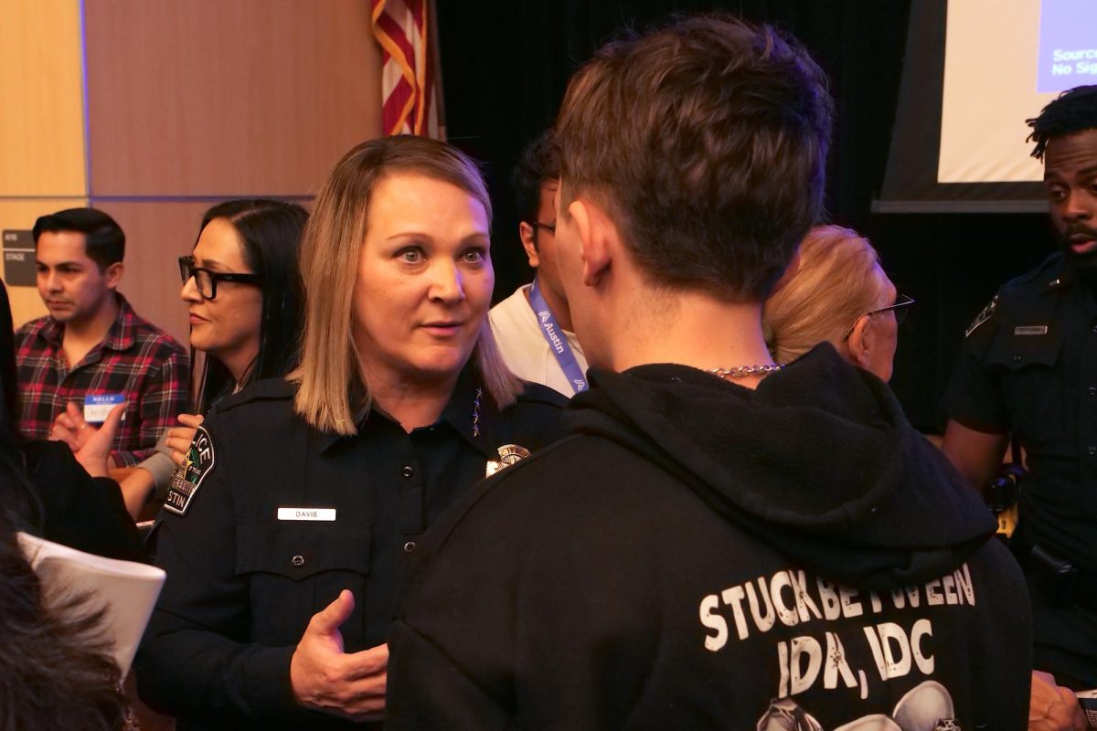 APD Chief Lisa Davis speaks with an attendee after a town hall at Govalle Elementary School in Austin, Texas, Feb. 5th, 2026.
