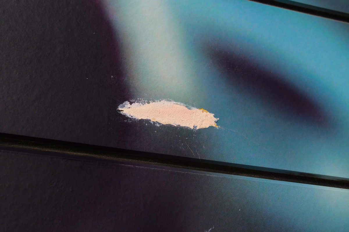 A patched-up hole left by a bullet on a mural near Buford's in Austin, Texas.