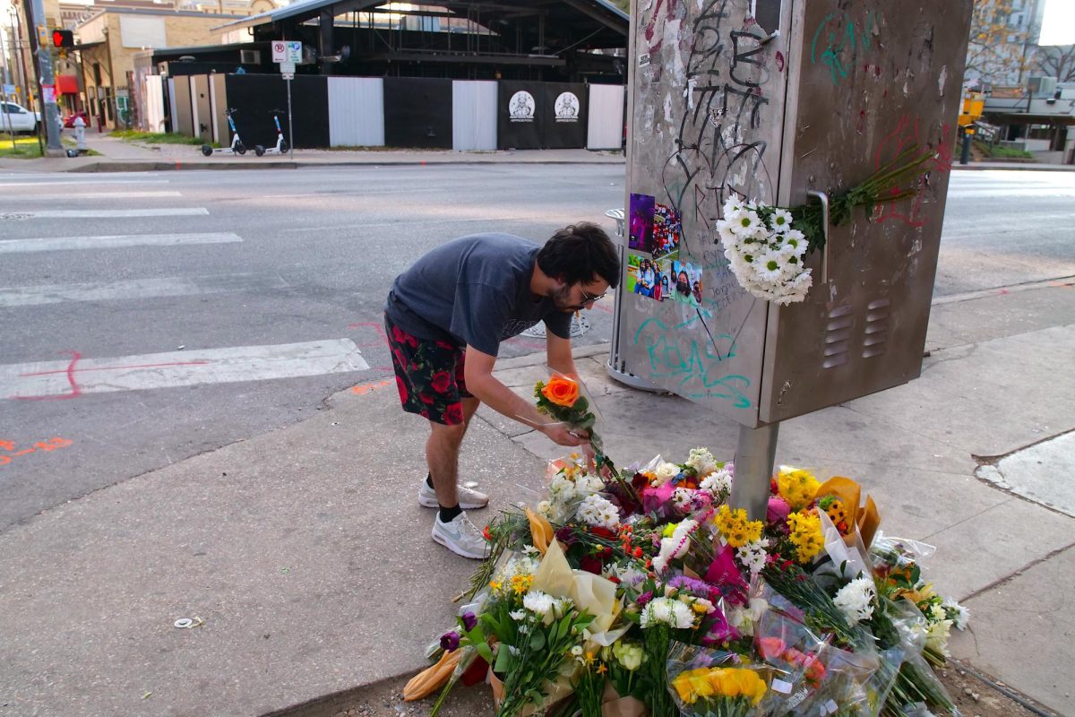 Avery Kellar, a 24-year-old who moved to Austin in Decmember, leaves a flower outside of Buford's on March 3.