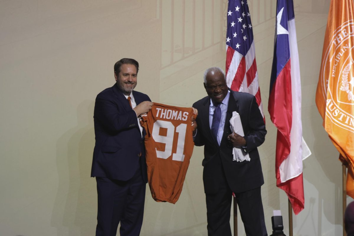 President Jim Davis gifts Thomas a custom UT jersey following his speech.